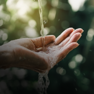 Hand and water flowing