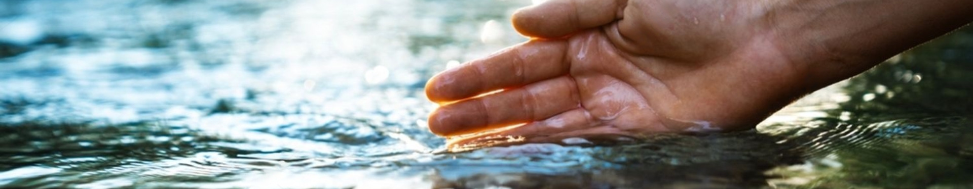 Hand in river with water