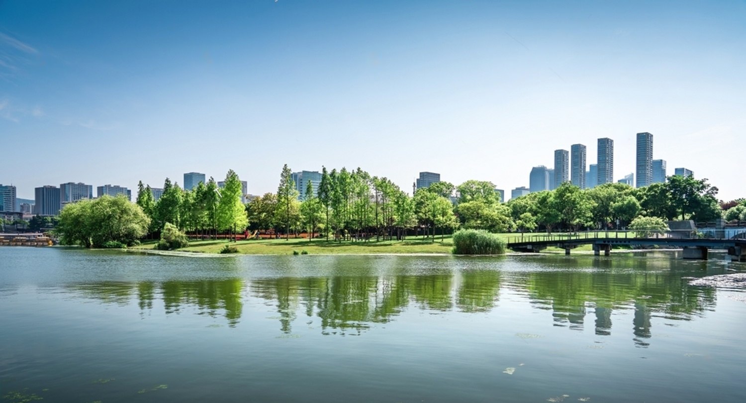 Lake with trees and building in the background