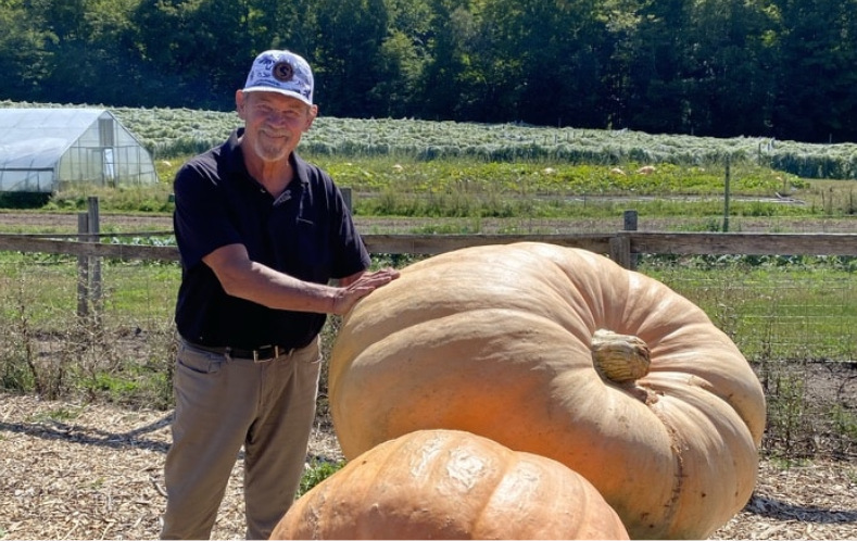 Man standing side pumpkin