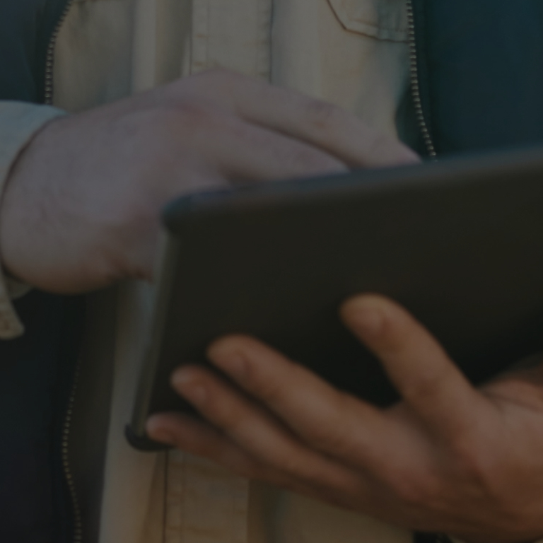 Man using tablet outside