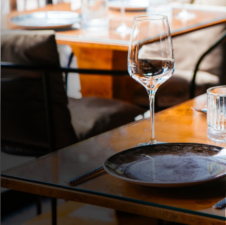 Table in restaurant with dish glass and cutlery