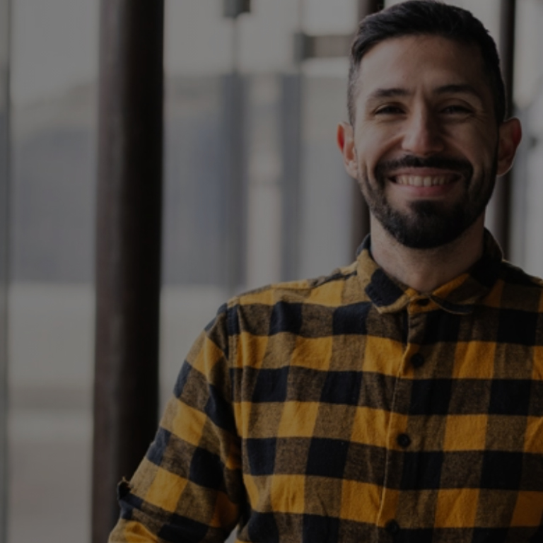 Young man at work and smiling to the camera