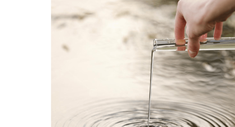 Hand putting water back to the lake